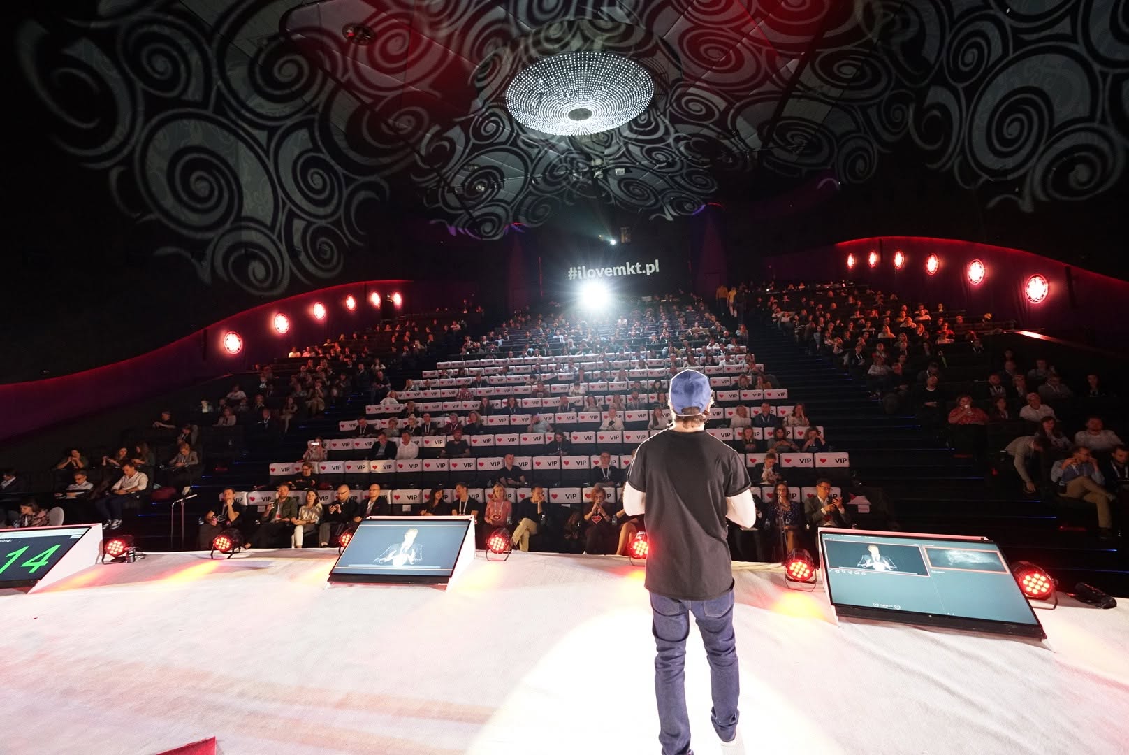 Bartek Sibiga speaking to a full conference auditorium